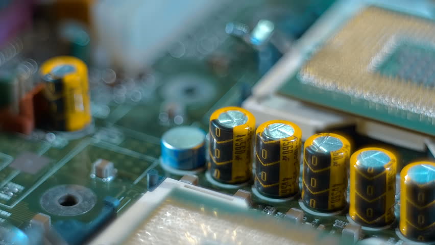 Powerful modern server computer motherboard with two processors. In inverted processors are a lot of conductive legs (contacts, pins) are visible. Closeup. Macro. Follow focus. Shot in motion