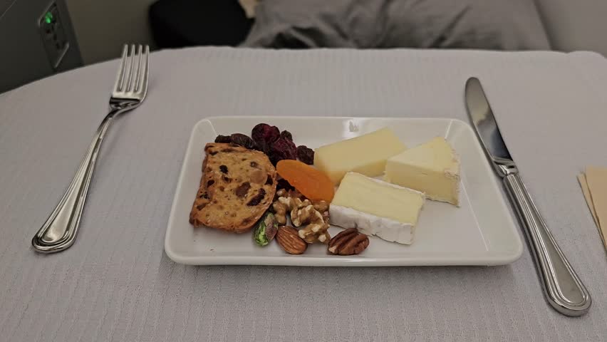 Elegant Indulgence: Cheese and Nuts Served in Prestige Class at 30,000 Feet