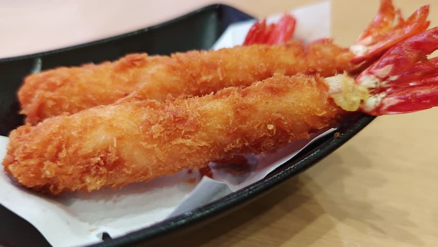Fried shrimp on a black plate