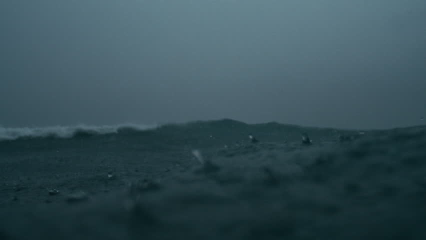 Close shallow focus captures rainfall dancing on storm darkened ocean surface