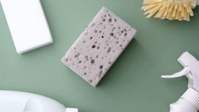 Set of cleaning supplies, sponges and spray bottle on a pastel green surface for home care - Powered by Shutterstock - Get 15% off with code: PIKWIZARD15