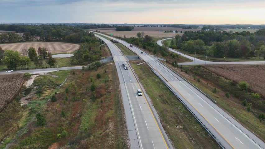 Aerial drone view of highway road in USA through forest landscape