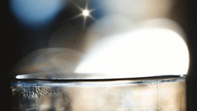 Abstract close-up of a brilliant light source reflecting on a metallic surface with a starburst lens flare and soft bokeh background - Powered by Shutterstock - Get 15% off with code: PIKWIZARD15