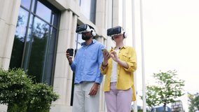 Two people wearing VR headsets explore a virtual reality experience outdoors in front of a modern building. - Powered by Shutterstock - Get 15% off with code: PIKWIZARD15