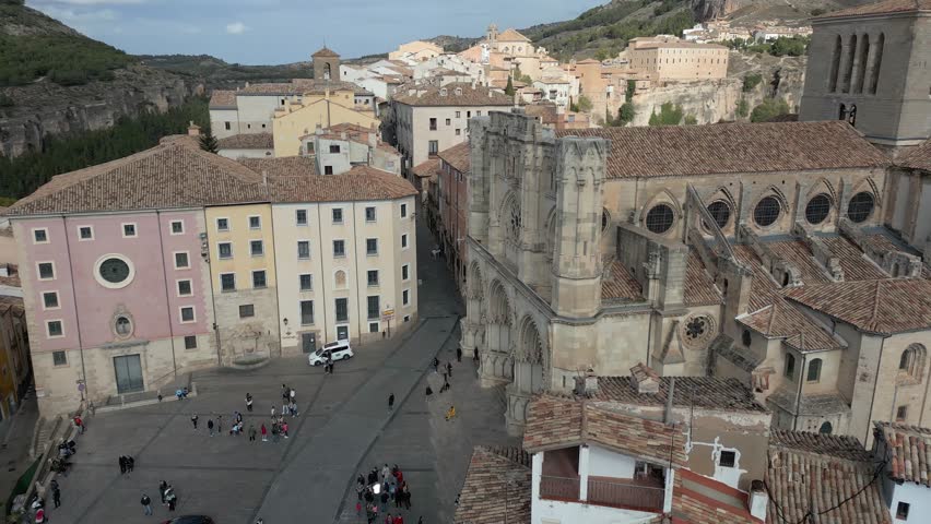 Aerial view of Cuenca Cathedral reveals the intricate architecture and the hustle of a vibrant city center, Cuenca, Castile-La Mancha, Spain.