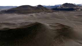 Cinematic aerial drone view of volcanic craters and lava fields in Iceland highlands, barren volcanic desert, rugged mountains and dramatic Nordic landscape, nature and geology background - Powered by Shutterstock - Get 15% off with code: PIKWIZARD15