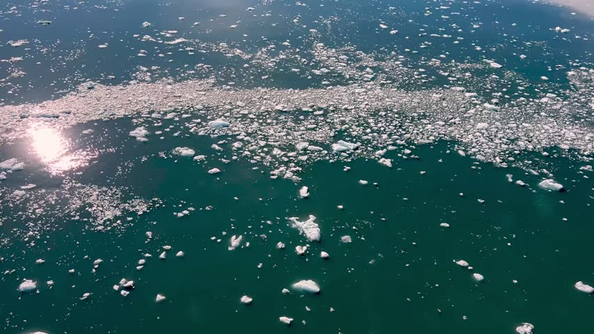 reflections in icy water near the hubbard glacier in alaska
