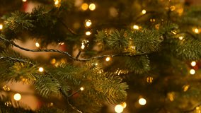 Woman adjusts the garland on a Christmas tree. A woman's hands adjust the festive garland, carefully decorating the Christmas tree at home - Powered by Shutterstock - Get 15% off with code: PIKWIZARD15