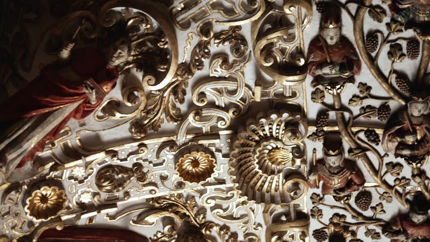Slow-motion left-to-right close-up inside Templo de Santo Domingo de Guzmán, highlighting gilded reliefs, gold-leaf altarpiece details, and ornate Baroque stucco motifs in low light.