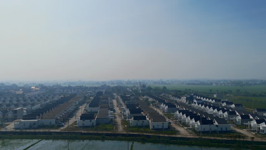 Aerial View of Suburban Houses Near Rural Farmland on Foggy Day