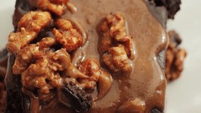 Chocolate brownies garnished with caramel and nuts. Sweet food. High quality 4k footage - Powered by Shutterstock - Get 15% off with code: PIKWIZARD15