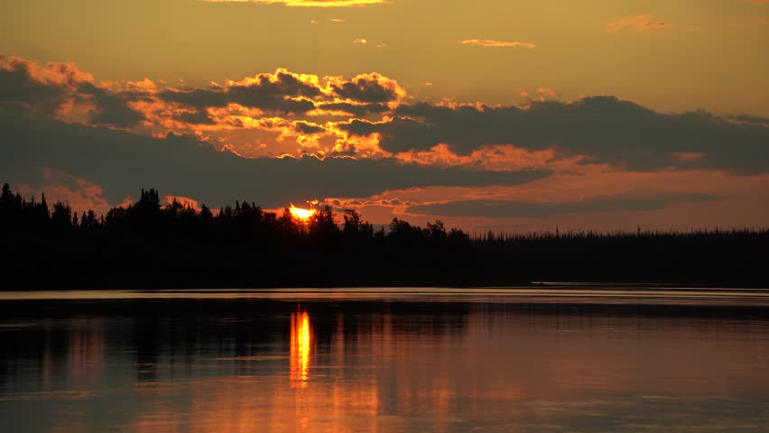 Red sunset over the forest near the lake