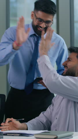 Business Arabian team Indian colleagues businessmen in office happy celebrating winning achieve discuss looking at computer happy celebrate work winning achieve financial growth success high five