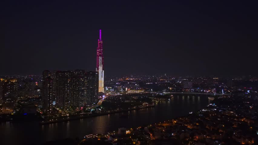Aerial night view of Ho chi minh or Saigon city with bridge at in Vietnam, illuminated skyscrapers.