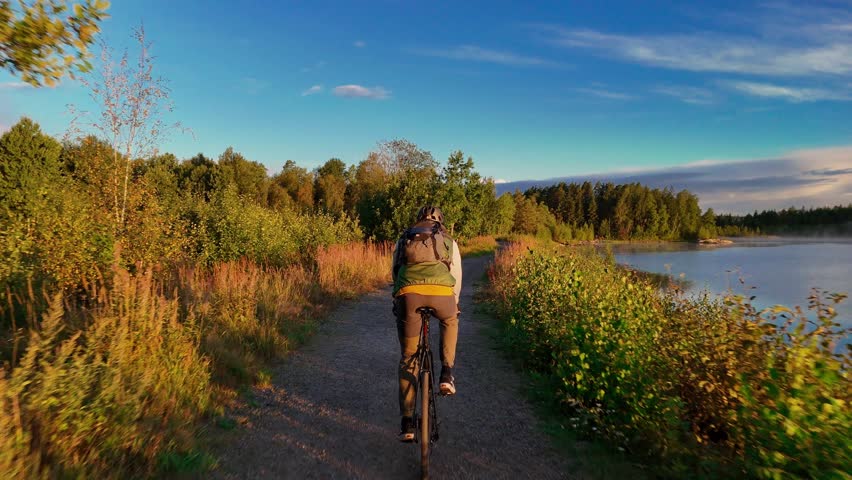 Morning Gravel Ride by Finnish Lake with Rising Mist and Sunrise
