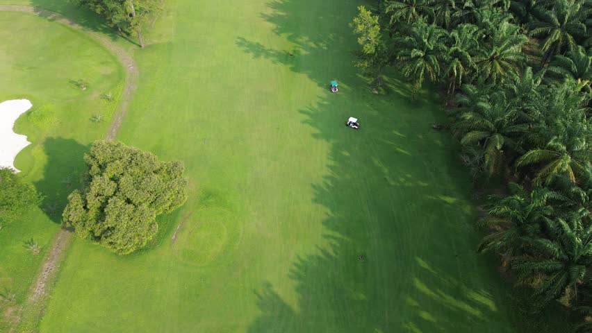 Top-Down Aerial View of Golf Course with Players and Carts