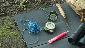 Outdoor Camping Survival Bushcraft Equipment with Compass Binoculars Knife and Glowstick Set on Foam 
Sleeping Mat - Powered by Shutterstock - Get 15% off with code: PIKWIZARD15