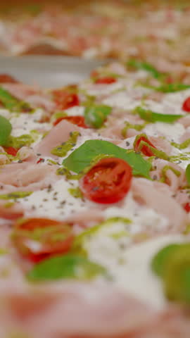 Close-up of one of the species of pizza on the baking sheet in a pizzeria in Rome. Typical Italian street food