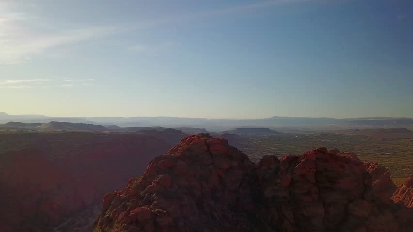 Panoramic view of desert landscape with red rock mountains and blue sky