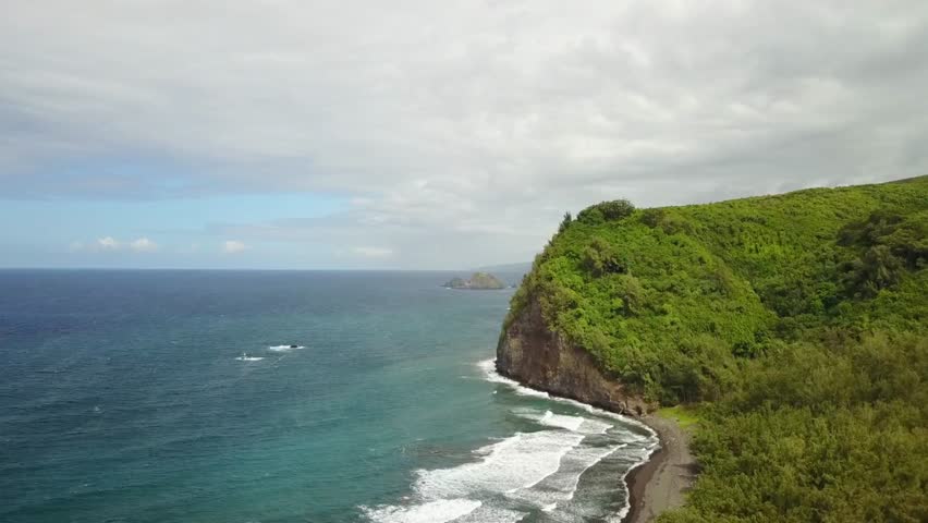 Aerial view of the green cliffs and blue ocean along the coast of hawaii island