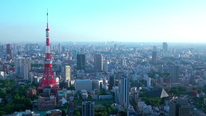 A panoramic view of the tokyo skyline with the tokyo tower in the foreground