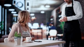 Contactless Payment At Coffee Shop Checkout: Happy Customer Uses NFC Smartwatch - Powered by Shutterstock - Get 15% off with code: PIKWIZARD15