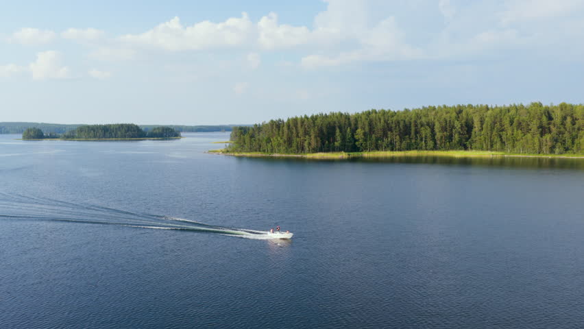 Panoramic aerial of a boat driving in the lakeland archipelago, summer in Finland