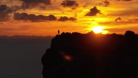 Traveler Watching Sunset over Menorca Clifftops, Aerial View with Gradient Sky - Powered by Shutterstock - Get 15% off with code: PIKWIZARD15