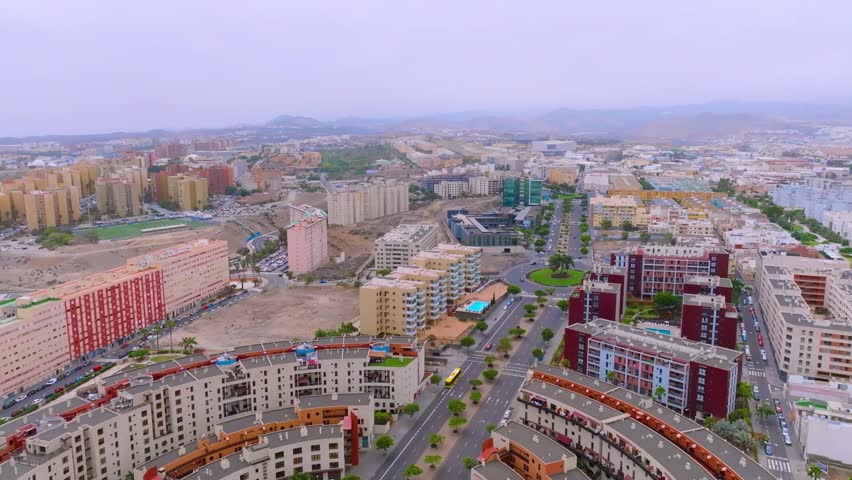Aerial view of Las Palmas cityscape under hazy calima skies