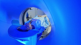 CT scanning of the spine examination for assess for herniated disk, tumors, extent of injuries, blood vessel malformations. Video computed tomography CT scan process for examination of spine. - Powered by Shutterstock - Get 15% off with code: PIKWIZARD15