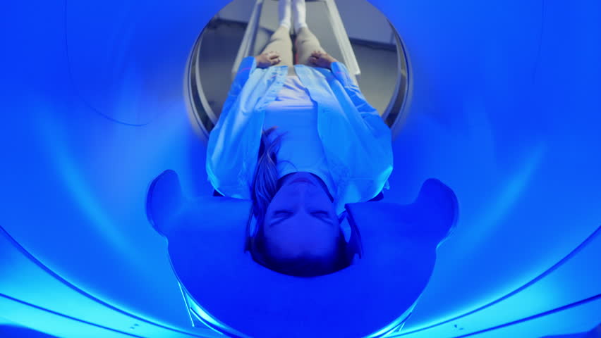 Women patient on CT MRI scanner. Woman moving on computed tomography or magnetic resonance imaging machine in diagnostic clinic. Video computed tomography CT scan process for examination of spine. - Powered by Shutterstock - Get 15% off with code: PIKWIZARD15