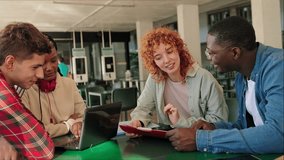 Happy diverse young university students studying together for exams with notes, cell phone and laptop at college library - Powered by Shutterstock - Get 15% off with code: PIKWIZARD15
