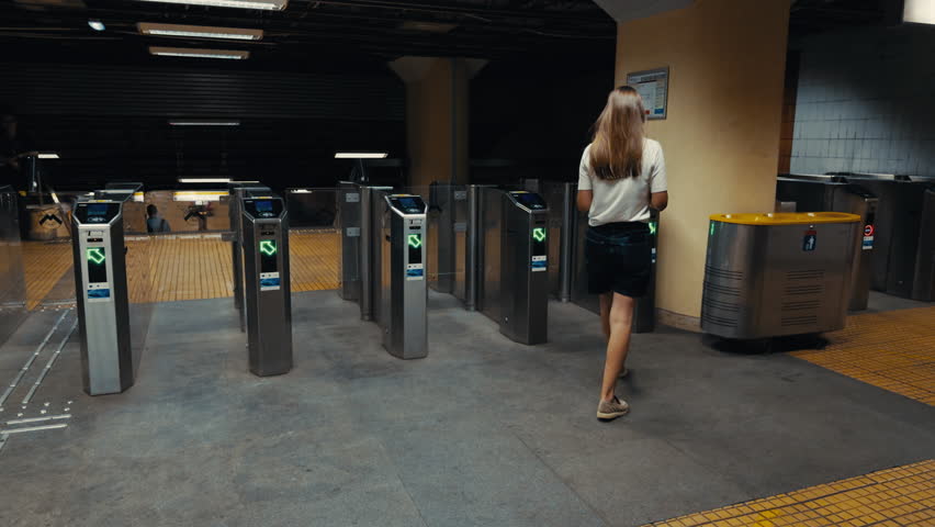 Female commuter navigates subway turnstiles, illustrating her journey from the busy streets to the underground transit environment, capturing the essence of urban life