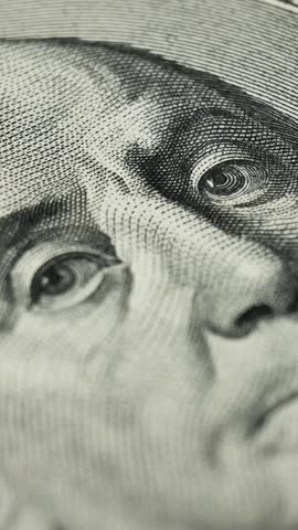 Detailed close up of 100 dollar bill featuring Benjamin Franklin. Legal tender used in both domestic and international trade. High value currency used for economic transactions