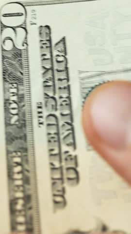 Hands counting 20 dollar bills. Legal tender used for rent payments, ensuring financial obligations, securing housing, and supporting budget planning within regulated economy 