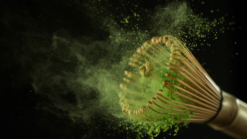 Super Slow Motion Detail Shot of Sprinkling Matcha Powder on Stirrer . Filmed on High Speed Cinematic Camera at 1000 FPS