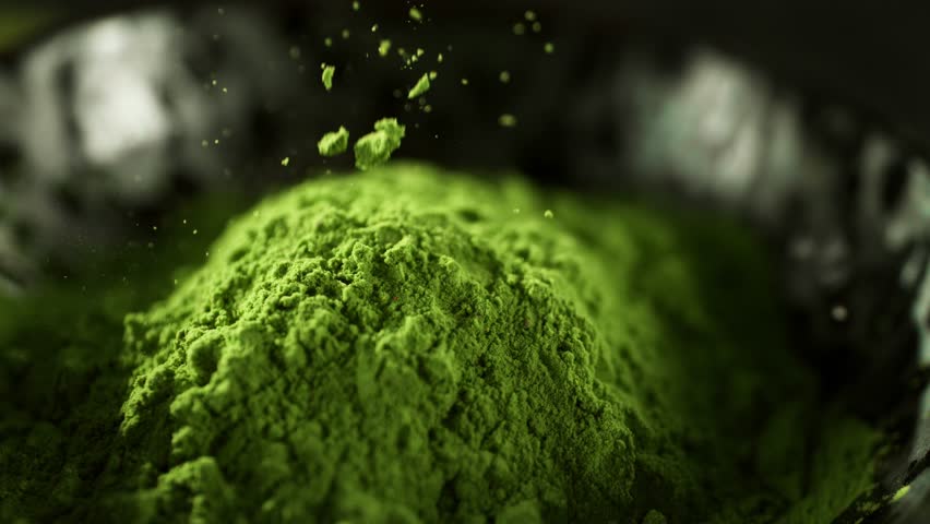 Super Slow Motion Detail Shot of Sprinkling Matcha Powder . Filmed on High Speed Cinematic Camera at 1000 FPS