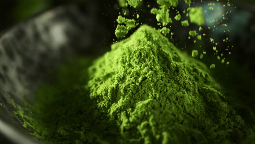 Super Slow Motion Detail Shot of Sprinkling Matcha Powder . Filmed on High Speed Cinematic Camera at 1000 FPS