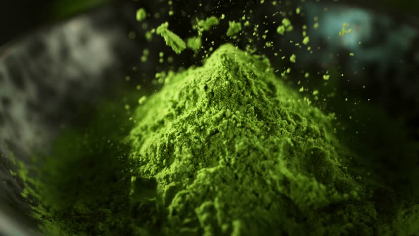 Super Slow Motion Detail Shot of Sprinkling Matcha Powder . Filmed on High Speed Cinematic Camera at 1000 FPS