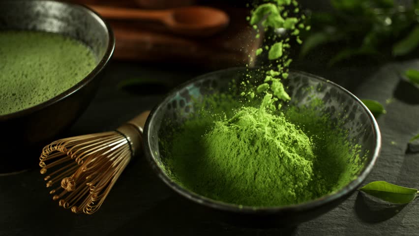 Super Slow Motion Detail Shot of Sprinkling Matcha Powder . Filmed on High Speed Cinematic Camera at 1000 FPS