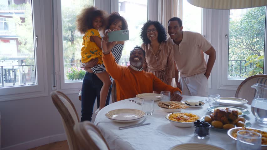 Storytelling image of a Family reunited at parents house for lunch on the holidays. Family members celebrating at home eating good food, sharing love and positive emotions - Powered by Shutterstock - Get 15% off with code: PIKWIZARD15