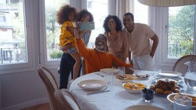 Storytelling image of a Family reunited at parents house for lunch on the holidays. Family members celebrating at home eating good food, sharing love and positive emotions - Powered by Shutterstock - Get 15% off with code: PIKWIZARD15