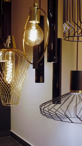 Chandeliers in store. assortment of illuminators for interior design. Many different types and shapes of lamps, chandeliers in store showroom. light interior decoration.