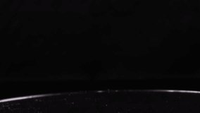 A close-up shot of orange slime pouring onto a dark, likely black surface - Powered by Shutterstock - Get 15% off with code: PIKWIZARD15