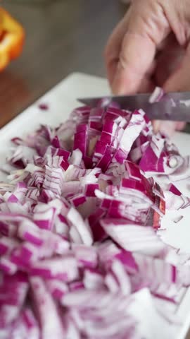 Chopping and Preparing Fresh Red Onions in the Kitchen During Meal Preparation Process