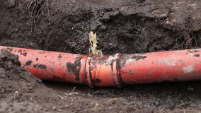 Dramatic Burst Sewer Pipe. Water and Sewage Gushing and Pouring on the Ground. a large volume of water and sewerage pouring out of a broken line, creating a chaotic scene on the ground outside. - Powered by Shutterstock - Get 15% off with code: PIKWIZARD15