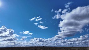 A timelapse captures summer clouds cumulus, cirrus, and stratus drifting over green countryside, revealing shifting light and peaceful motion - Powered by Shutterstock - Get 15% off with code: PIKWIZARD15