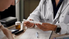 Medical consultation for diabetes. Doctor explains insulin pen injection to diabetic patient. Diabetes treatment, healthcare education, and chronic disease management - Powered by Shutterstock - Get 15% off with code: PIKWIZARD15