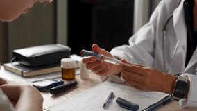 Medical consultation for diabetes. Doctor explains insulin pen injection to diabetic patient. Diabetes treatment, healthcare education, and chronic disease management - Powered by Shutterstock - Get 15% off with code: PIKWIZARD15