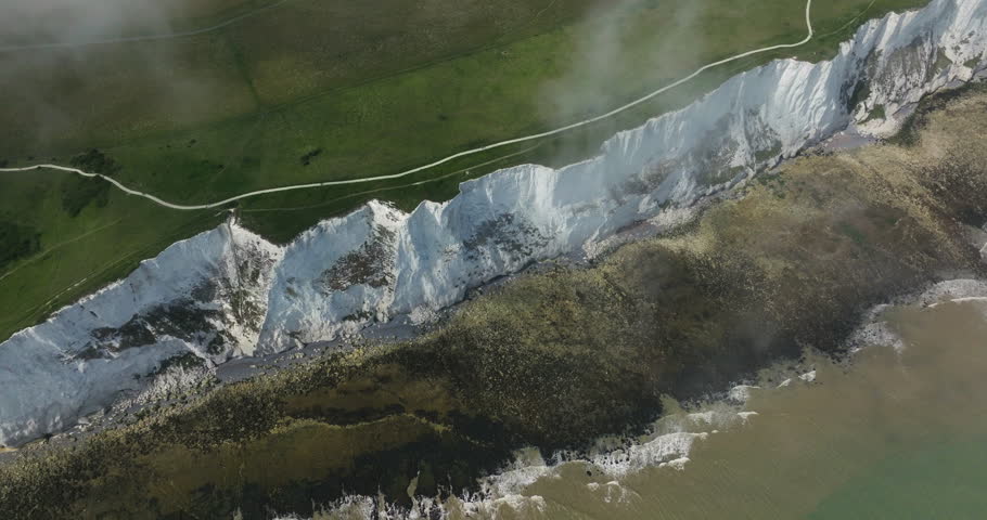 Dover White Cliffs With Streaks Of Black Flint And Rocky Coastline In Kent, England, UK. - aerial shot
